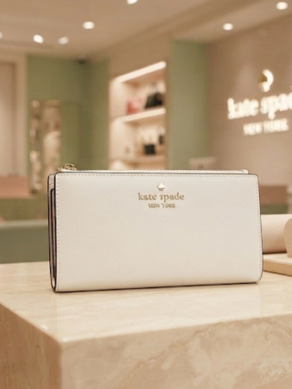 kate spade cream saffiano leather wallet with gold logo